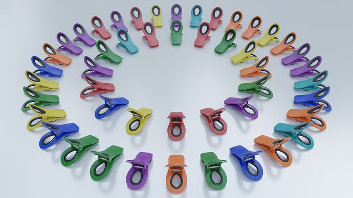 Assorted rainbow color chip clips arranged in two concentric circles on a white flat surface