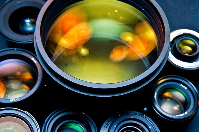 1280px-Photographic_lenses_front_view